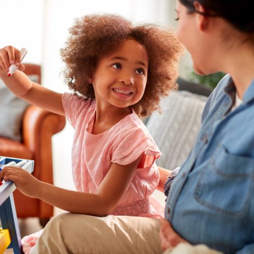 mother-daughter-having-fun-drawing-picture-whiteboard-home-together